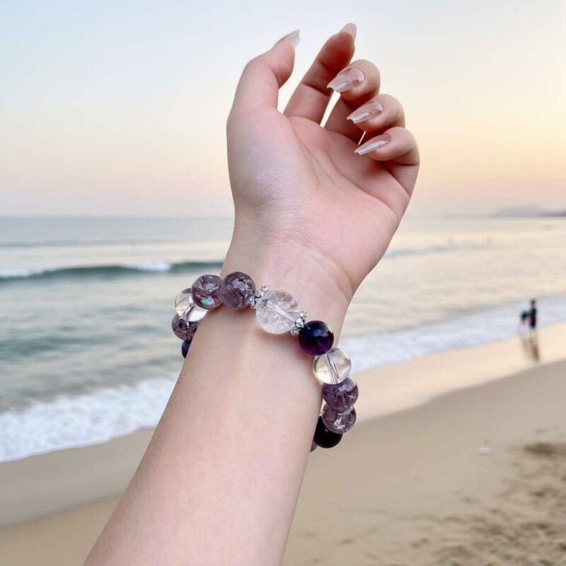 A woman wearing the Bing Fire crystal energy bracelet, showing how it looks on the wrist.