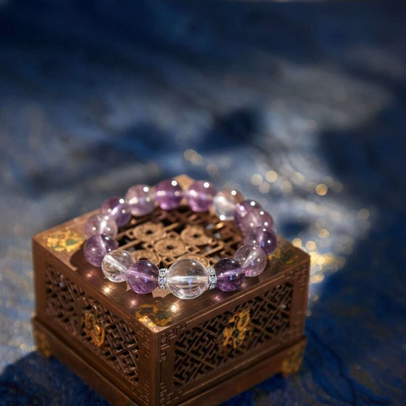 A Bing Fire crystal bracelet with amethyst and clear quartz beads.