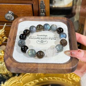 A close-up detail shot of the Gray quartz crystal bead on the Aquarius Zodiac.
