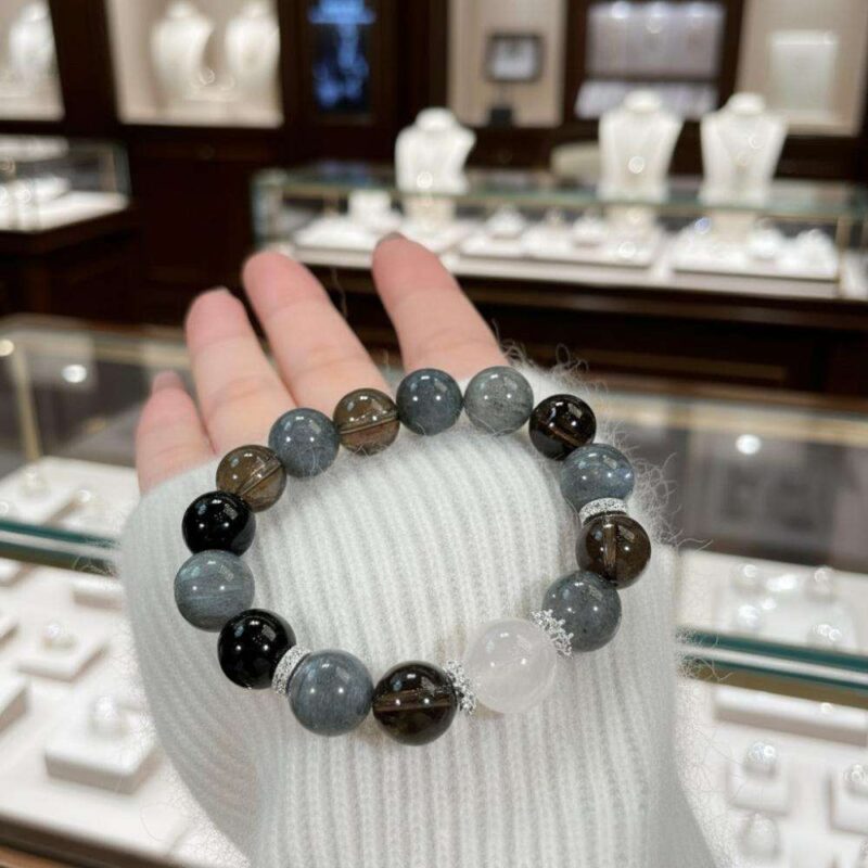 A woman wearing the Aquarius Zodiac crystal energy bracelet, showing how it looks on the wrist.