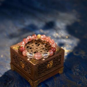 A Aries Zodiac Crystal Bracelet with red lodolite quartz beads.