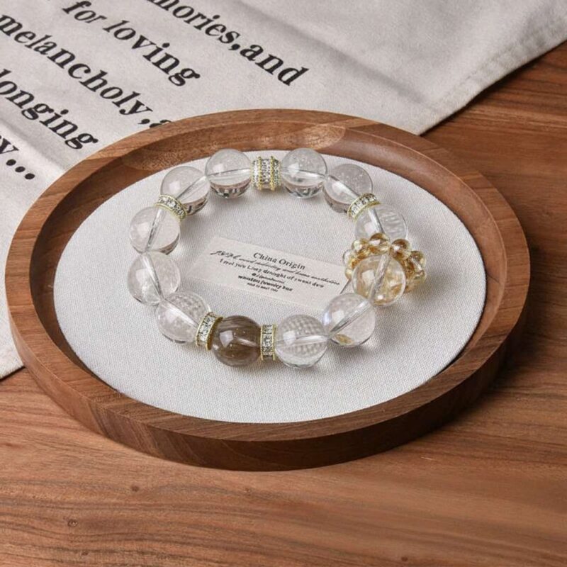 A close-up detail shot of the red lodolite quartz crystal bead on the Capricorn Zodiac.