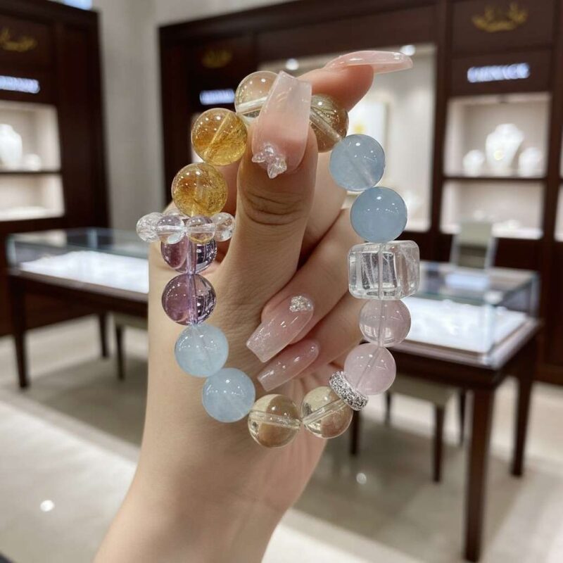 A woman wearing the Gemini Zodiac crystal energy bracelet, showing how it looks on the wrist.