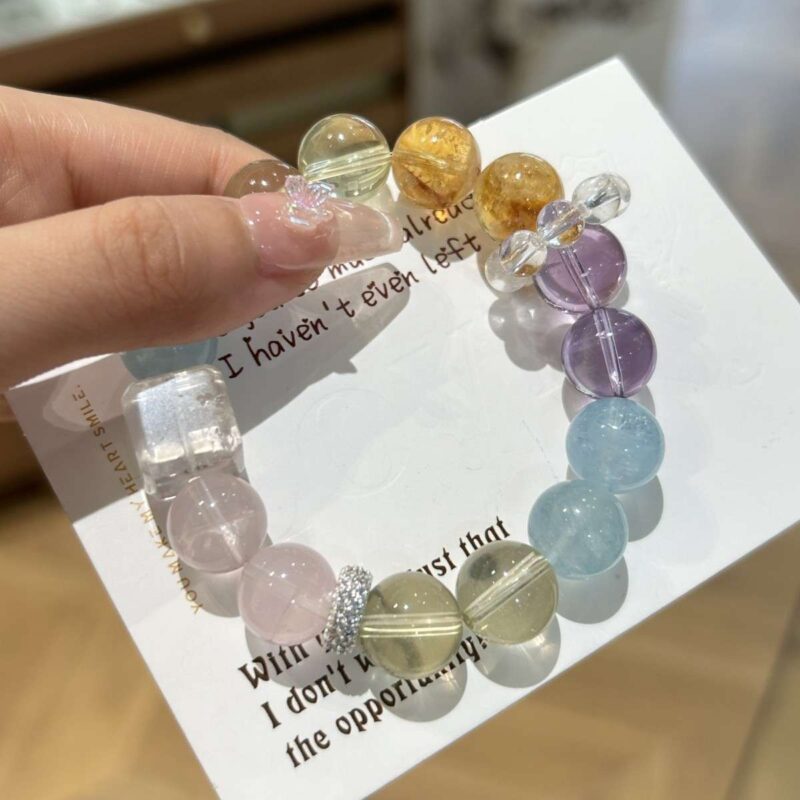 A close-up detail shot of the Aquamarine quartz crystal bead on the Gemini Zodiac.