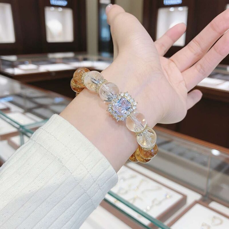 A woman wearing the Leo Zodiac crystal energy bracelet, showing how it looks on the wrist.