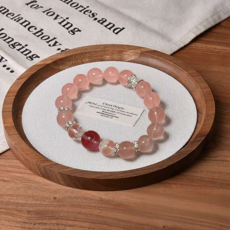 A close-up detail shot of the Rose quartz crystal bead on the Libra Zodiac.