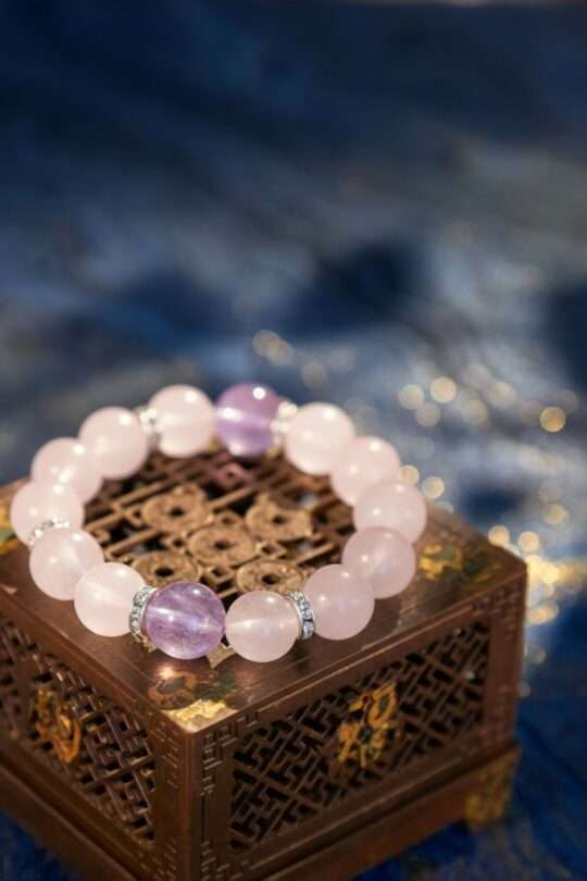 A Pisces Zodiac crystal bracelet with Rose quartz beads. Alt Text 2: A close-up detail shot of the Rose quartz crystal bead on the Piscess Zod