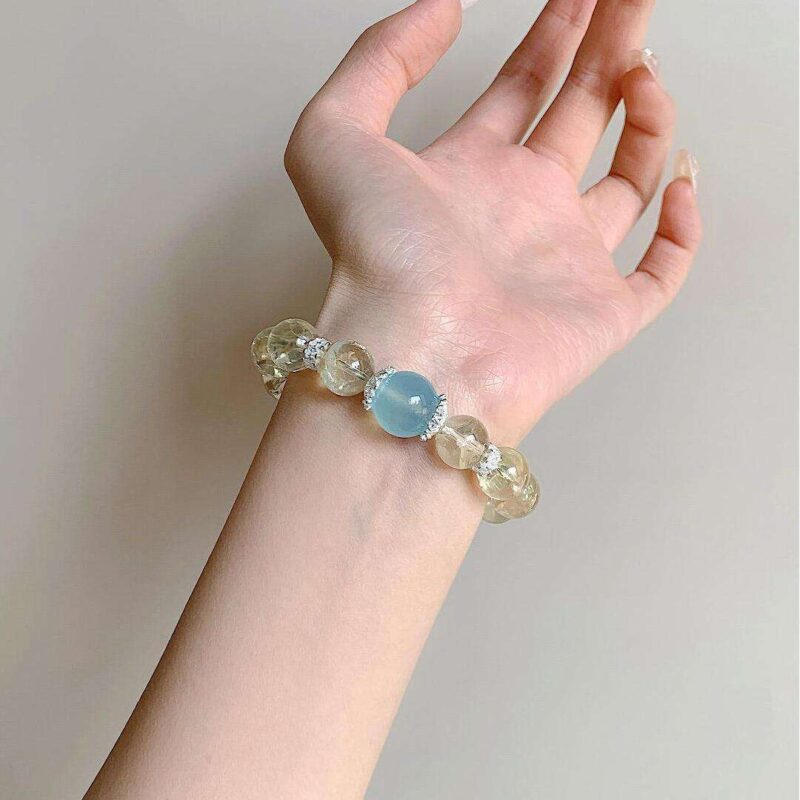A woman wearing the Sagittarius Zodiac crystal energy bracelet, showing how it looks on the wrist.
