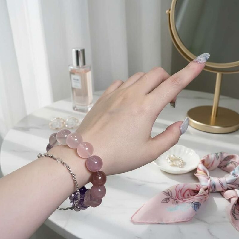 A woman wearing the Scorpio Zodiac crystal energy bracelet, showing how it looks on the wrist.