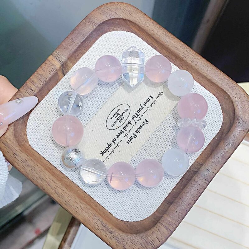 A close-up detail shot of the Rose quartz crystal bead on the Virgo Zodiac.