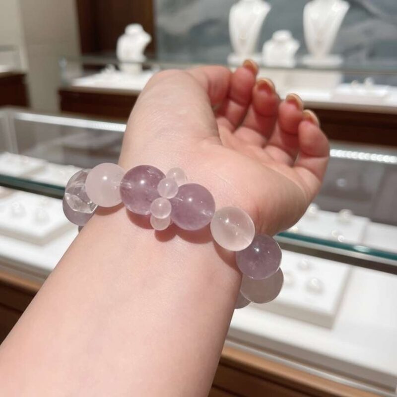 A woman wearing the Virgo Zodiac crystal energy bracelet, showing how it looks on the wrist.