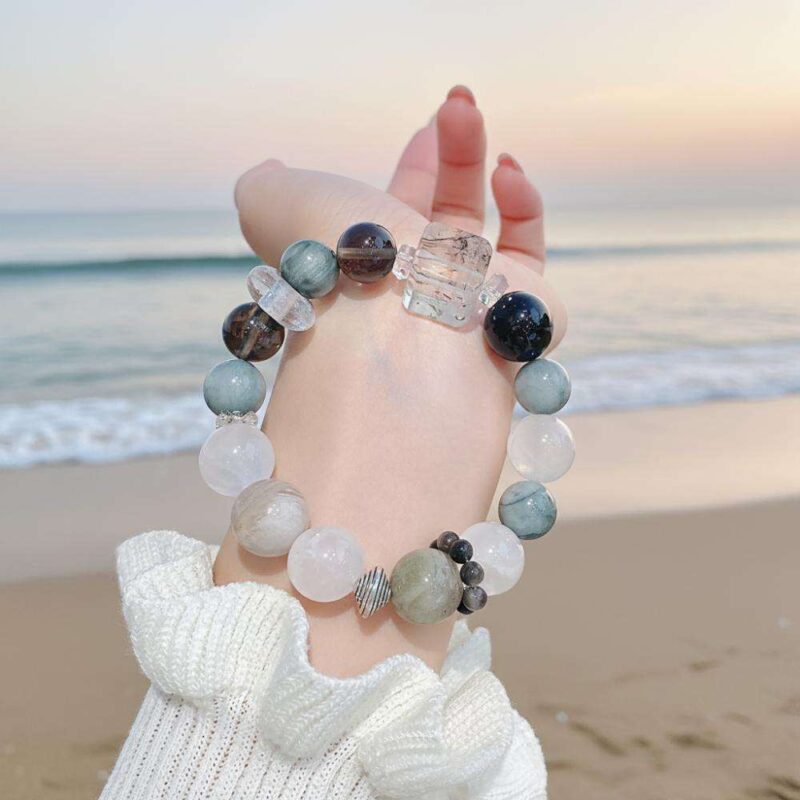 A woman wearing the Chinese Dog Zodiac crystal energy bracelet, showing how it looks on the wrist.