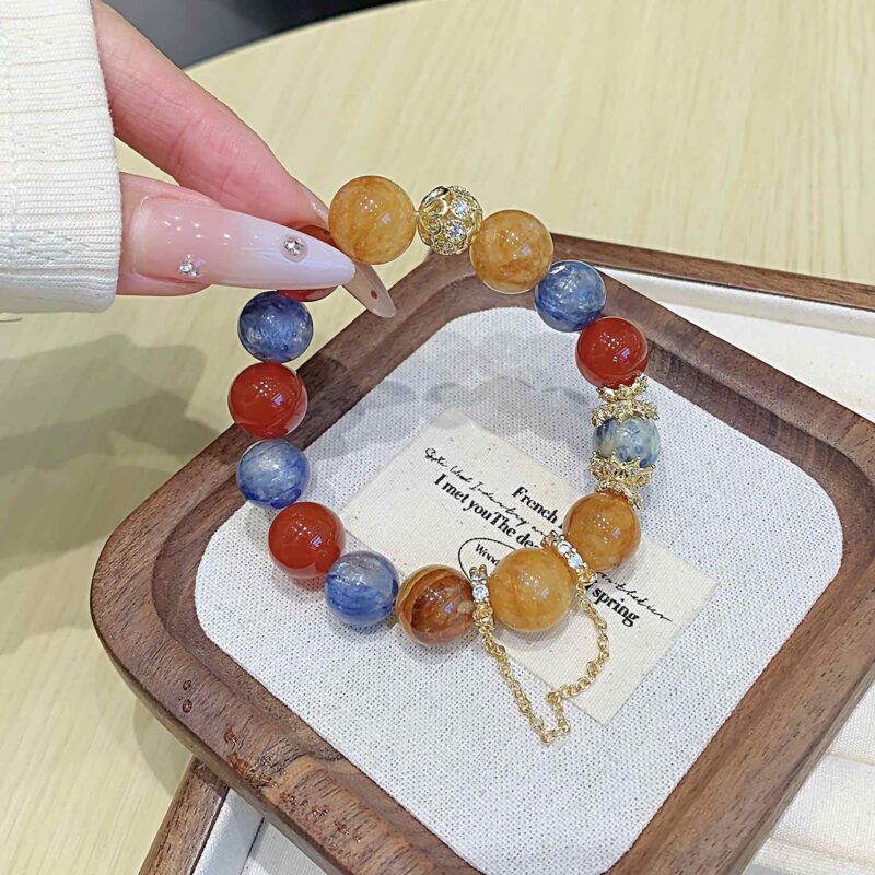 A close-up detail shot of the green rutilated quartz crystal bead on the Chinese Dragon Zodiac.