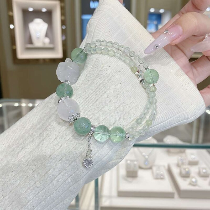 A woman wearing the Chinese Goat Zodiac crystal energy bracelet, showing how it looks on the wrist.