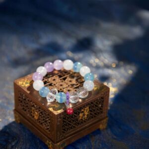 A Chinese Rat Zodiac crystal bracelet with green rutilated and phantom quartz beads.