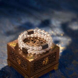 A Chinese Rooster Zodiac crystal bracelet with green rutilated and phantom quartz beads.