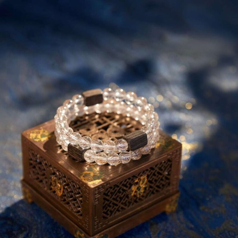 A Chinese Rooster Zodiac crystal bracelet with green rutilated and phantom quartz beads.