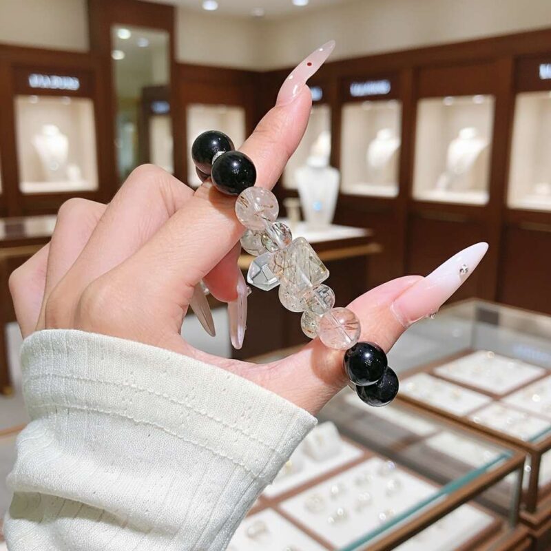 A woman wearing the Snake Chinese Zodiac crystal energy bracelet, showing how it looks on the wrist.