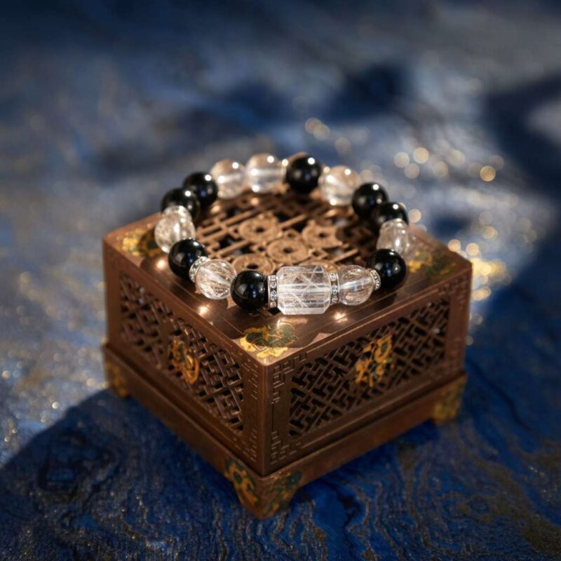 A Chinese Snake Zodiac crystal bracelet with green rutilated and phantom quartz beads.