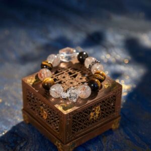 A Chinese Tiger Zodiac crystal bracelet with green rutilated and phantom quartz beads.