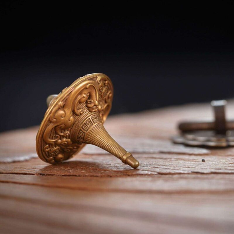 A close-up of the precision-engineered, durable tip of the brass fidget spinner, designed for a long and stable spin.