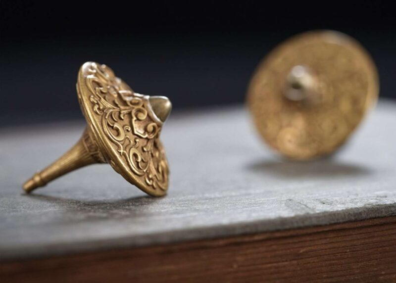 A close-up of the precision-engineered, durable tip of the brass fidget spinner, designed for a long and stable spin.