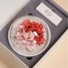 A beautifully handcrafted white and pink peony flower ceramic diffuser resting in its elegant grey and white gift box.