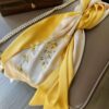 An elegant gold, open Handmade Suzhou Embroidery Silk Gift Box displaying its contents: a hand-embroidered silk scarf, an ebony hairpin, a pearl necklace, and an enamel brooch.
