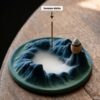 Incense Sticks burning in a ceramic holder, with a peaceful wisp of fragrant smoke rising upwards.