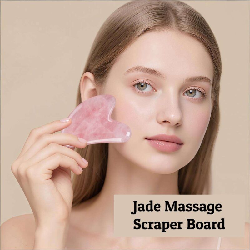 A woman demonstrates how to use a jade gua sha facial tool on her face.