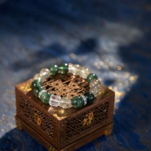 A Jia Wood crystal bracelet with green rutilated and phantom quartz beads
