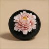 The handmade flower ceramic diffuser shown in a stunning pink peony color variation.