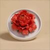 The handmade flower ceramic diffuser shown in a stunning red peony color variation.