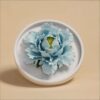 The handmade flower ceramic diffuser shown in a stunning blue peony color variation.