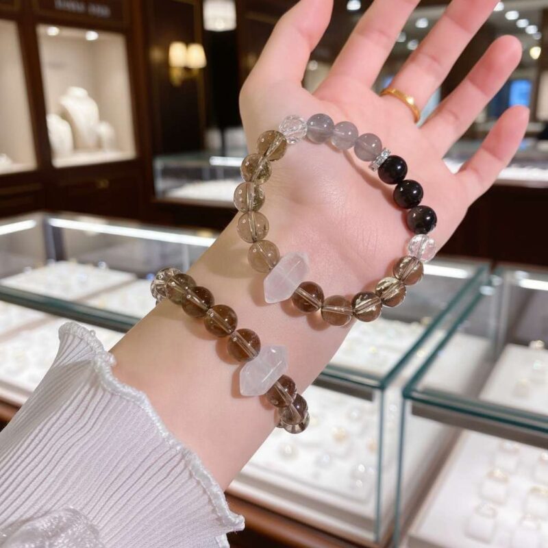 A woman wearing the Ren Water crystal energy bracelet, showing how it looks on the wrist.