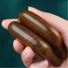 A collection of several artisanal sandalwood massage combs arranged beautifully, showcasing the natural variations in the wood.