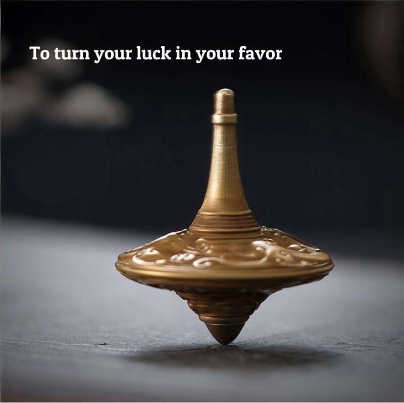 The elegant brass fidget spinner resting on a modern executive desk next to a leather-bound book, serving as a sophisticated focus tool.