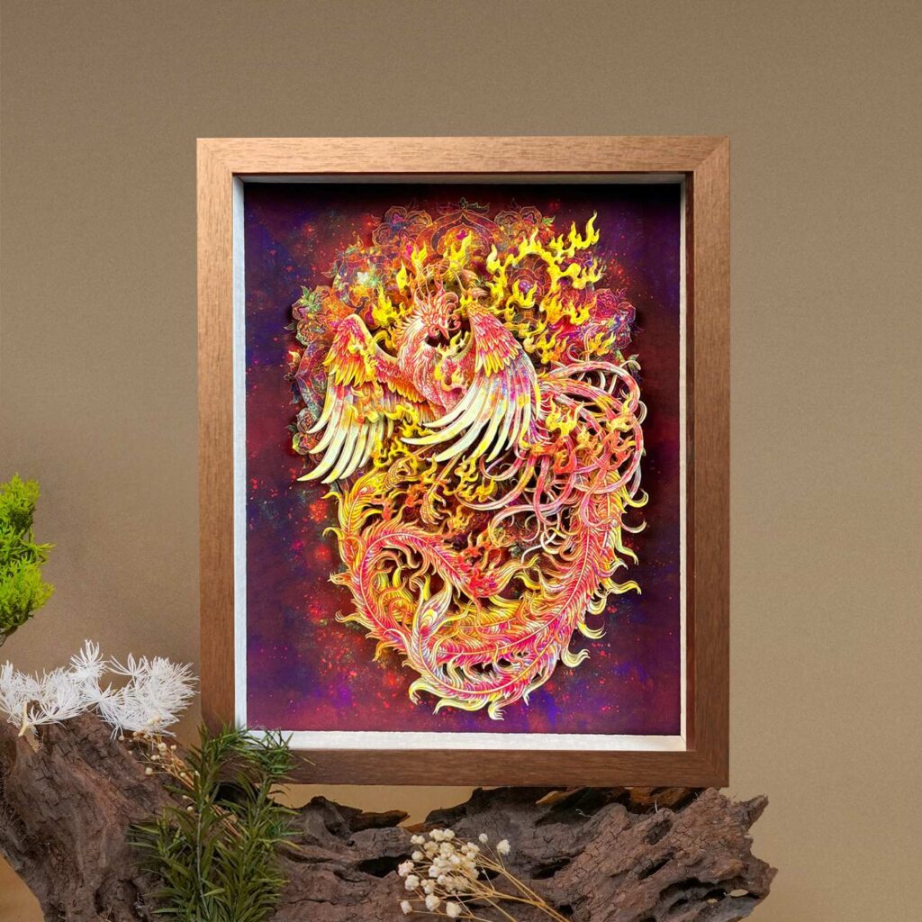 Woman holding a framed 3D Chinese Paper Cutting Fenghuang artwork, showing the colorful Phoenix facing the sun against a walnut wood frame.