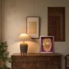 Elegant 3D Chinese Paper Cutting Fenghuang shadow box displayed on a rustic wooden stand, representing harmony and rebirth in Feng Shui decor.