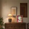 Elegant walnut framed 3D Chinese Paper Cutting artwork placed on a shelf, adding a touch of oriental Zen and Feng Shui fortune to the room.