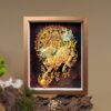 Framed 3D Chinese Paper Cutting Qilin art piece displayed on driftwood, showcasing the intricate golden scales and fiery design of the mythical beast
