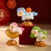 Cute Year of the Horse Creative Spring Ornament figures displayed together, showing the resin craftsmanship and different symbols like persimmons and strawberries.