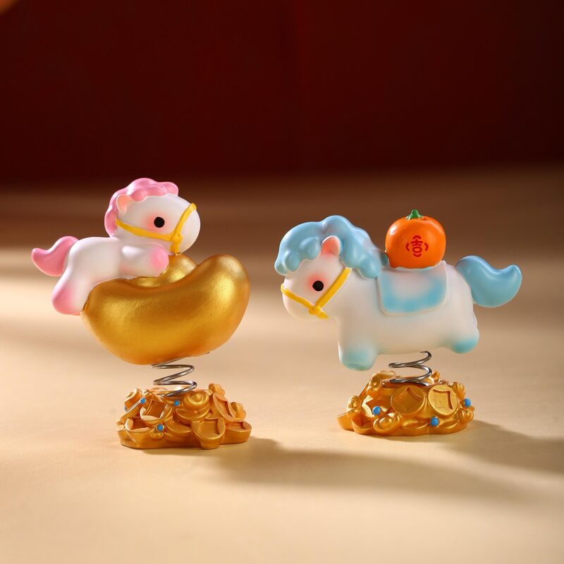 Cute Year of the Horse Creative Spring Ornament figures displayed together, showing the resin craftsmanship and different symbols like persimmons and strawberries.