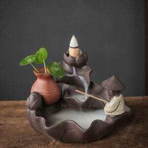 Ceramic Backflow Incense Burner Fishing Alone style featuring a fisherman figure, a smoke waterfall, and a small green plant in a vase.