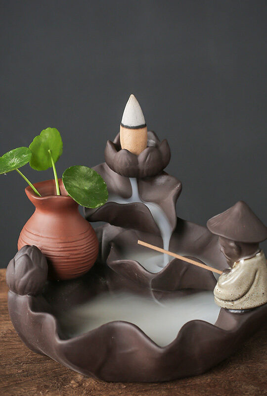 Ceramic Backflow Incense Burner Fishing Alone style featuring a fisherman figure, a smoke waterfall, and a small green plant in a vase.