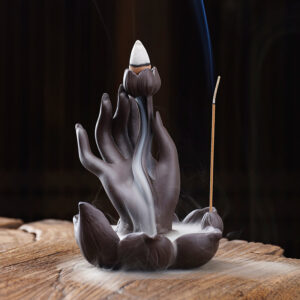 Purple clay Backflow Incense Burner Buddha Hand with a lotus flower design, sitting on a white background.