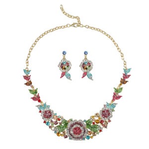 Sapphire blue Luxury Crystal Glass Party Jewelry Set featuring a blooming rose statement necklace and matching floral dangle earrings on a black display.