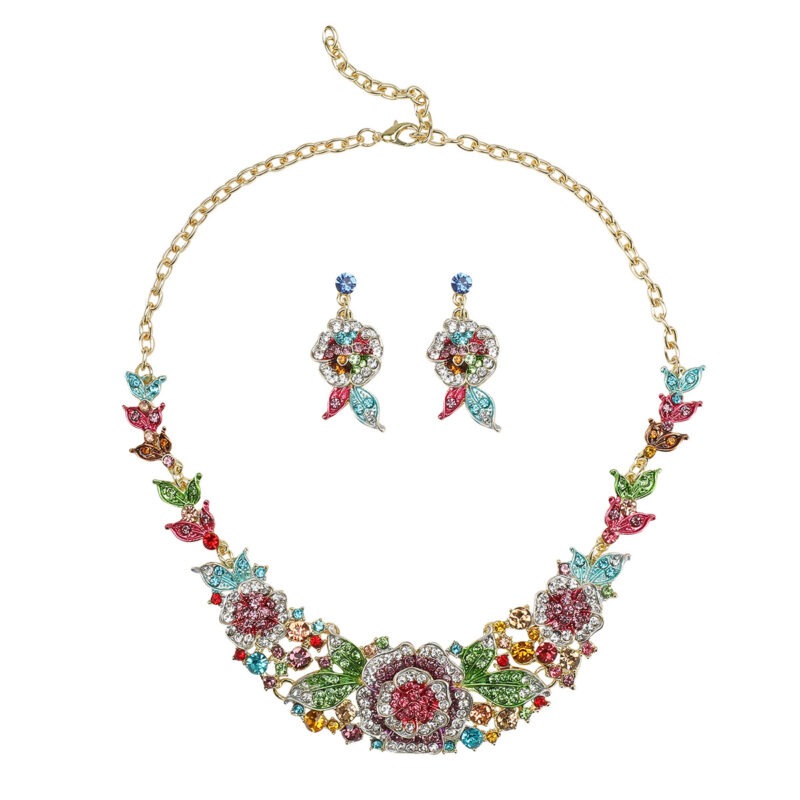 Sapphire blue Luxury Crystal Glass Party Jewelry Set featuring a blooming rose statement necklace and matching floral dangle earrings on a black display.